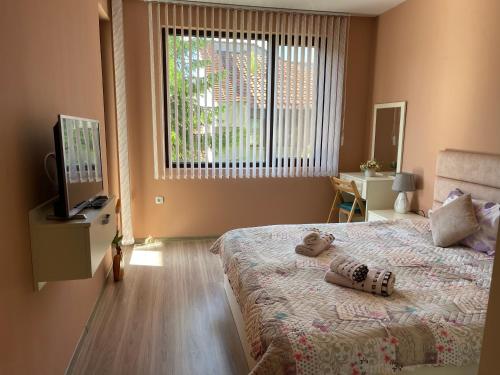 ein Schlafzimmer mit einem Bett mit einem Teddybär darauf in der Unterkunft Nikol Deluxe in Welingrad