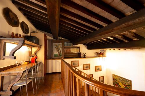 comedor con mesa y sillas y techo de madera en Book and Bed, en Orvieto