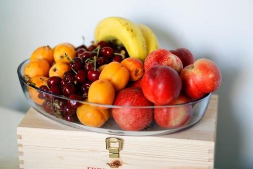 a bowl of fruit on top of a wooden table at Maison Canopée in Messina