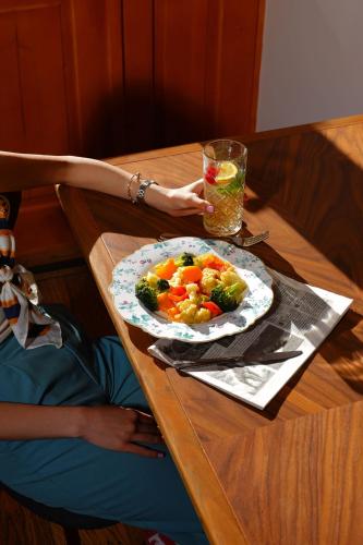 a person sitting at a table with a plate of food at Toon Armeni Guest House in Dilijan