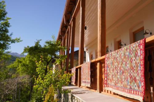 a building with carpets on the side of it at Toon Armeni Guest House in Dilijan