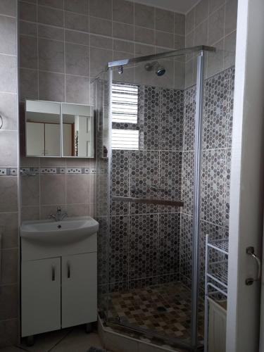 a bathroom with a shower and a sink at South Coast Riviera - 805 in Port Shepstone