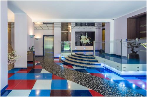 a lobby with a colorful floor and stairs at Klijanu street design studio in city centre in Rīga