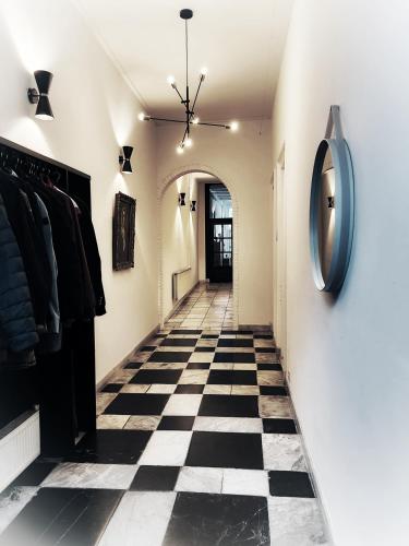 a hallway with a black and white checkered floor at Elf bed and breakfast in Bolsward