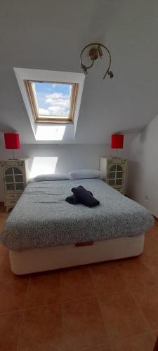 a bedroom with a bed in a room with a window at Casa Melitona in Castiello de Jaca