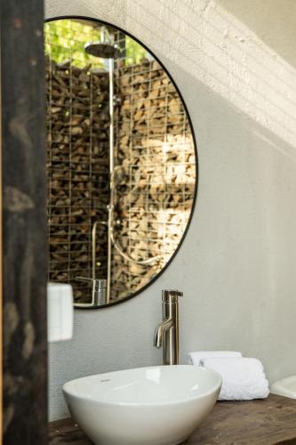 a bathroom with a white sink and a mirror at Sky Glamping boutique in Moshav Ramot