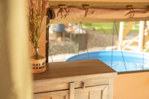 a vase with flowers in it sitting on a table at Sky Glamping boutique in Moshav Ramot