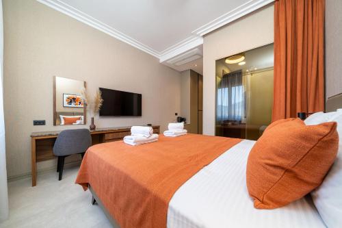 a hotel room with a bed and a desk at C Group apartments in Kotor