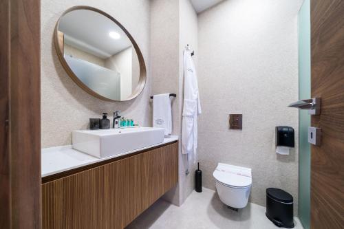 a bathroom with a sink and a mirror and a toilet at C Group apartments in Kotor