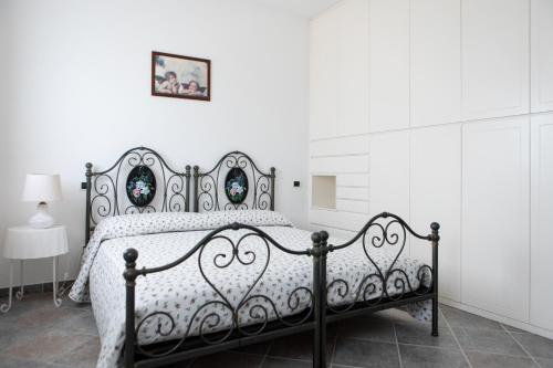 a bedroom with a black bed with a white bedspread at FONTE D'OLIO CONERO RELAIS in Sirolo