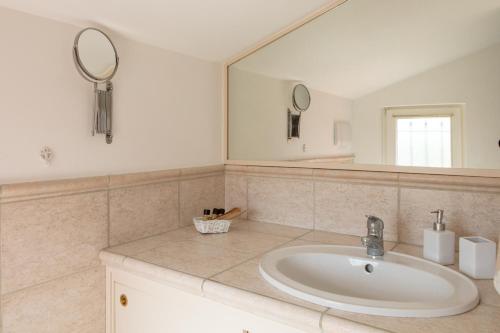 a bathroom with a sink and a mirror at FONTE D'OLIO CONERO RELAIS in Sirolo