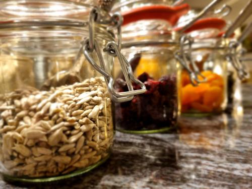 a group of glass jars filled with nuts and fruits at Moselhotel Weinhaus Simon `Sauna`Restaurant`ELadesäule in Wintrich