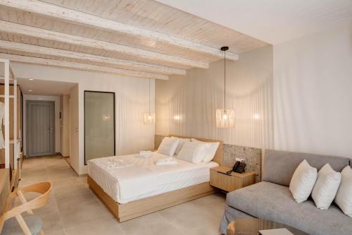 a bedroom with a bed and a couch at Alboro seaside suites in Parga