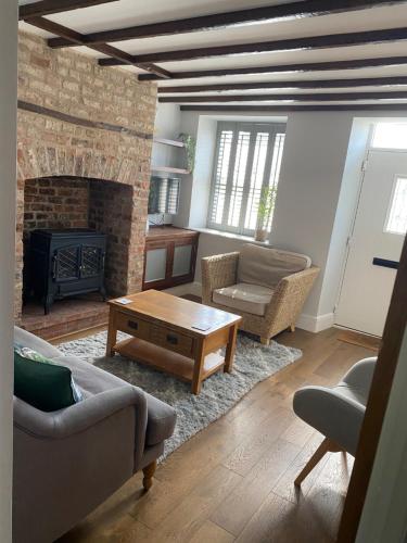 a living room with a couch and a fireplace at 71 Main Street in Bishopthorpe