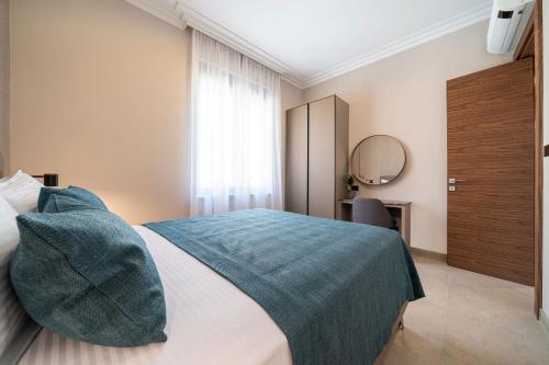a bedroom with a bed with a blue blanket on it at C Group apartments in Kotor