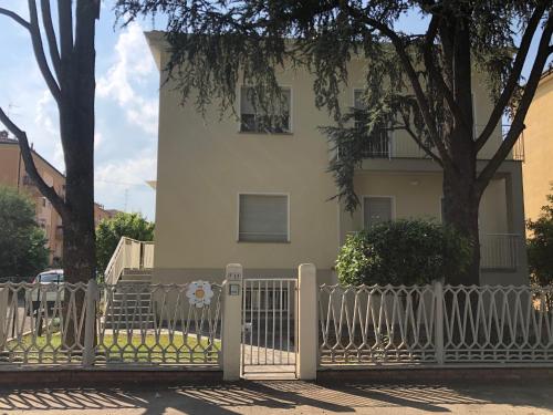 a white fence in front of a house at Appartamento a due passi dal centro storico di Imola in Imola