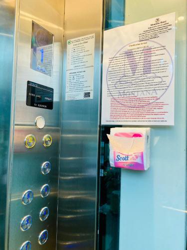 a metal elevator with a sign on the side of it at Montana Hotel Songkhla in Songkhla