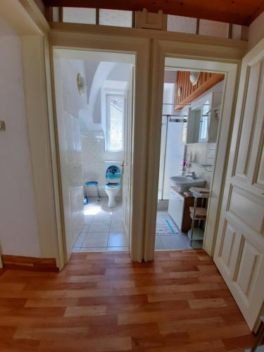 a hallway with a bathroom with a sink and a toilet at Gästehaus zur Post - Heritage Inn in Spital am Pyhrn