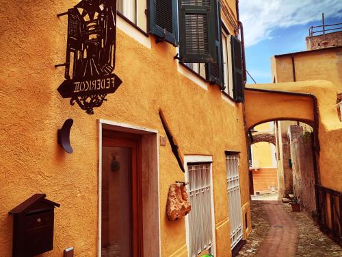 a building with a sign on the side of it at Federico II - Rooms and Breakfast in Borgio Verezzi