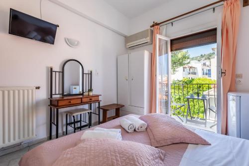 a bedroom with a bed and a window at Regina Hotel in Skopelos Town