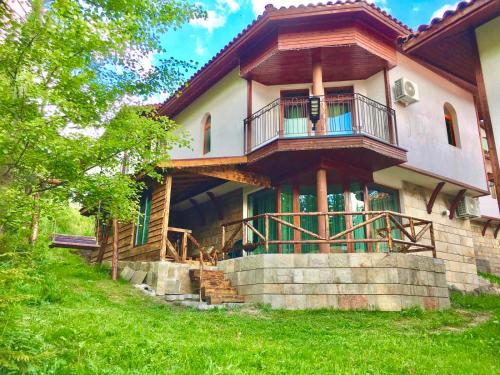 a house with a balcony on the side of it at Pamporovo Villa in Pamporovo