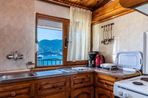 a kitchen with a sink and a window at Regina Hotel in Skopelos Town