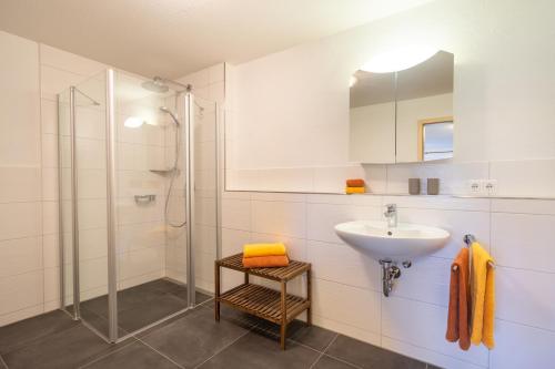 a bathroom with a sink and a shower at Ferienwohnungen Alpentraum - Traumblick in Bolsterlang