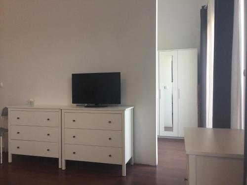 a living room with a dresser with a television on it at Platan 17 in Świnoujście