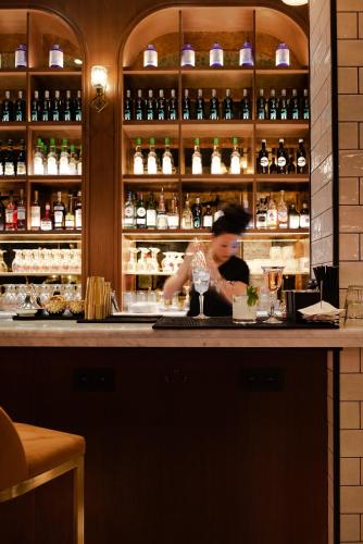 a woman preparing a drink at a bar at Craves in Brussels