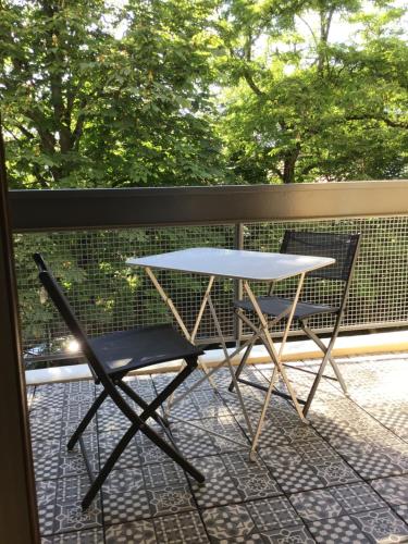 d'une table et d'une chaise sur un balcon. dans l'établissement Grand T2 5min du centre historique D'Aix en Provence, à Aix-en-Provence