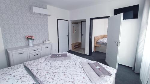 a bedroom with a bed with two towels on it at Penzion HARMONIE in Trhové Sviny