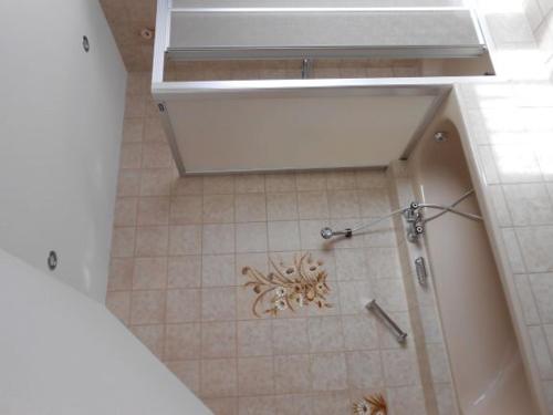 a bathroom with a sink and a tiled floor at Ferienhof Fischer in Seebach