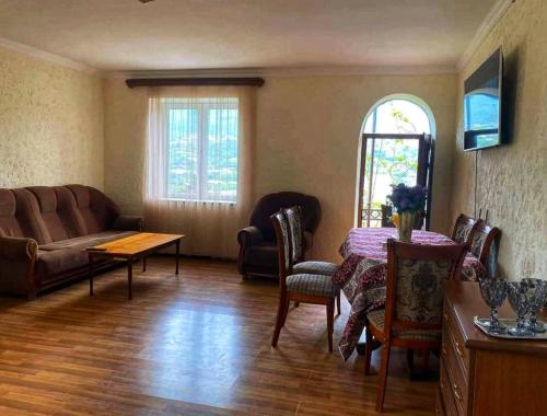 a living room with a couch and a table at EleGaya Guest house in Ijevan