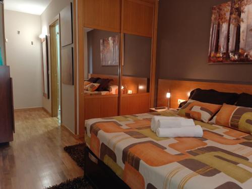 a bedroom with a large bed in a room at A PONTE in Padrón