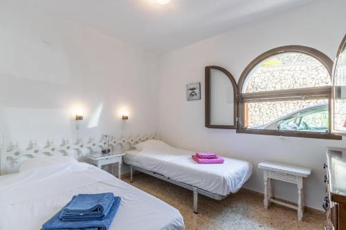 Giường trong phòng chung tại Villa Pendulo