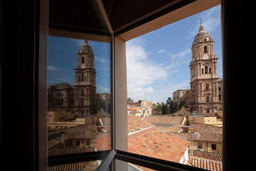 a view of the roofs of buildings from a window at Petit Palace Plaza Málaga in Málaga