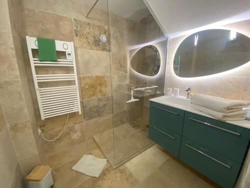 une salle de bain avec une douche, un lavabo et un miroir dans l'établissement Villa la Margeride, à Sainte-Maxime