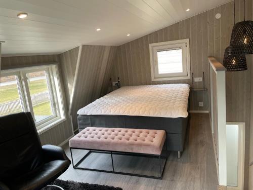 ein kleines Schlafzimmer mit einem Bett und einer Bank in der Unterkunft TinyHouze in Karlskrona