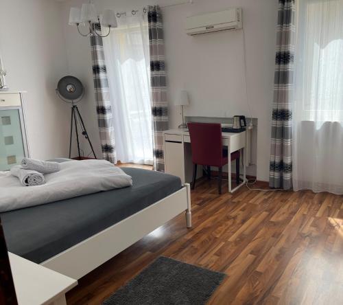 a bedroom with a bed and a desk and a desk at Hotel Schweizer Stubb in Kaiserslautern