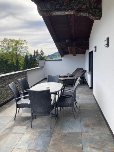 a patio with a table and chairs on a balcony at Camping Inntal in Wiesing