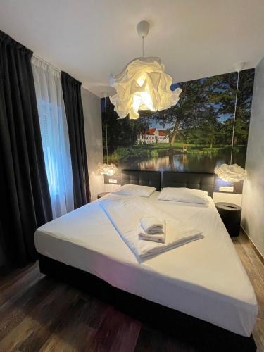 a bedroom with a large bed with a large painting on the wall at Gec in Zaprešić
