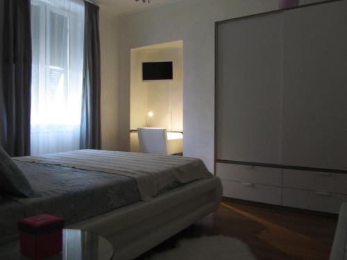 a bedroom with a bed and a large window at B&B Borgo Marina in Bordighera