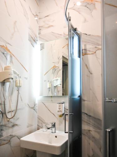 a bathroom with a sink and a shower at Zamek w Krokowej in Krokowa