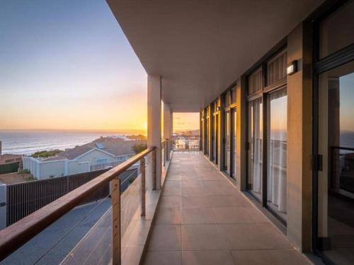 a balcony of a building with a view of the ocean at Anchor's Haven Hersham in Groot Brak Rivier