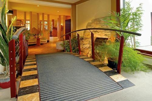 a walkway in a house with a stone wall at Panoramahotel Lilienstein in Königstein an der Elbe