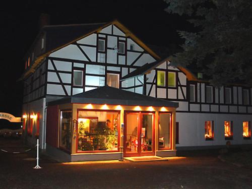 a house is lit up at night at Panoramahotel Lilienstein in Königstein an der Elbe