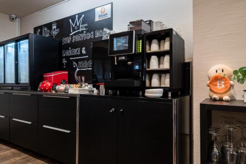 a restaurant with a black counter with a pumpkin on it at Princess No3 Self Check-In Plochingen bei Stuttgart in Plochingen