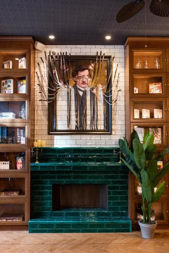 a fireplace with a picture of a man on the wall at Craves in Brussels