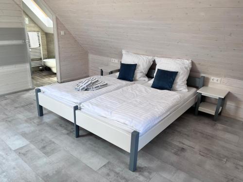 a large bed in a room with at Beck's Borveranda Palkonya in Palkonya