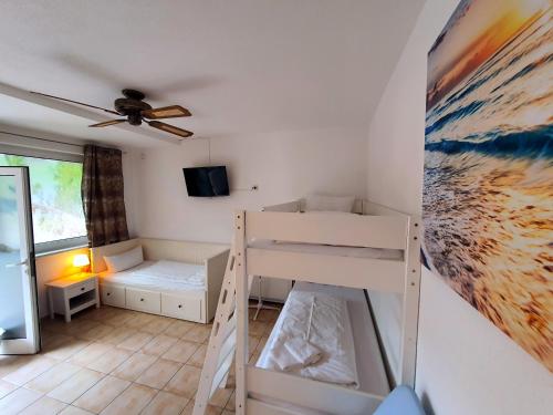 a bedroom with a bunk bed and a ceiling at Gästehaus Parkblick in Rust
